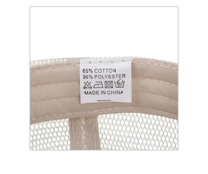 Detail view of cotton-polyester mesh cap showing washing label and breathable fabric