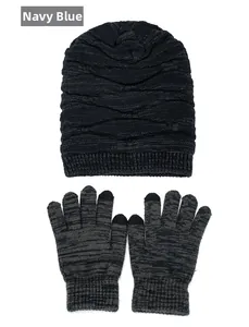Detail of navy blue winter knit beanie and touch screen gloves with wavy pattern