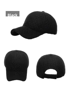 Detailed view of black knitted baseball cap showing diamond grid texture and adjustable strap