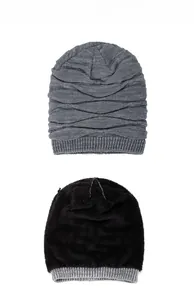 Detail view of winter knitted beanie showing gray ribbed exterior and warm black fleece lining