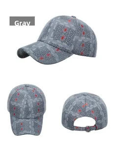 Detail view of grey baseball cap with red spider prints and mesh texture details