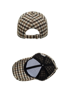 Detail view of plaid baseball cap showing metal buckle and inner fabric lining