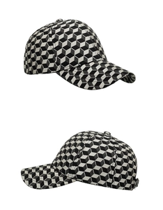 Detail of winter baseball cap featuring black and white 3D geometric cube patterns