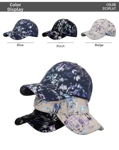Close-up of baseball caps in blue, black, and beige with abstract graffiti prints