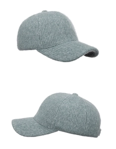 Detail of gray-blue knitted baseball cap featuring thick fuzzy texture and ribbed patterns
