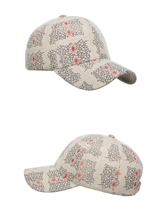 Close-up of baseball cap featuring mesh patterns and red floral splash prints