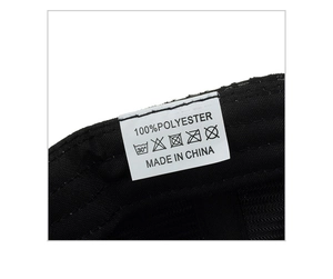 Detailed macro view of the 100% polyester fabric lining and care label on the baseball cap