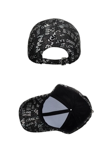 Detail view of adjustable metal buckle and graffiti print on black baseball cap