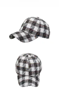 Detailed views of plaid tweed baseball caps showing fabric texture and checkered pattern