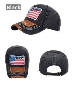 Close-up of black vintage washed cotton baseball cap with US flag patch and leather brim detail