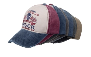 Multiple vintage washed baseball caps in various colors with retro truck graphics