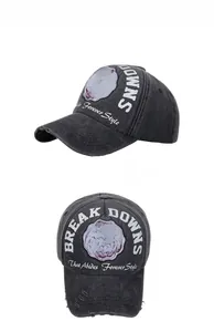 Macro shot of dark grey washed cotton baseball cap with vintage embroidery and worn detail
