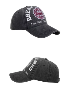 Detailed macro view showing distressed vintage washed cotton baseball cap with letter embroidery