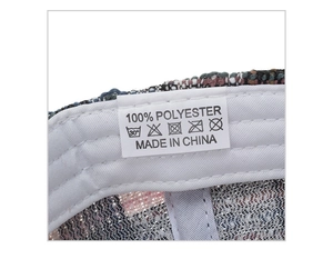 Detail showing 100% polyester material wash label inside the plaid baseball cap