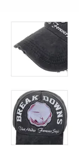 Detailed macro view showing the distressed brim and vintage letter embroidery on the black cap