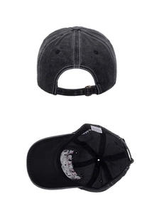 Detail of vintage washed cotton baseball cap showing adjustable metal buckle and inner stitching