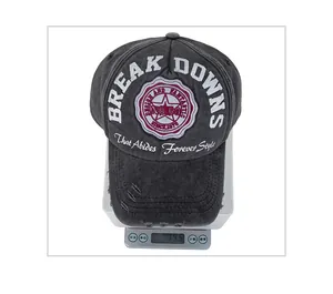 Detail showing vintage washed grey cotton baseball cap weight on digital scale