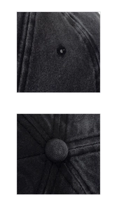 Detail of black corduroy baseball cap showing top button and embroidered eyelets