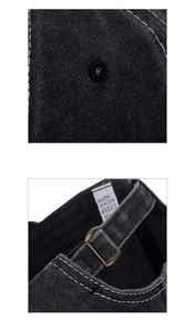 Detail of black cotton baseball cap showing metallic buckle and white stitching details