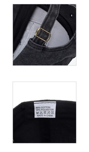 Detail view of washed cotton baseball cap showing bronze metal buckle and fabric care label