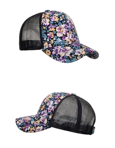 Detail of floral trucker hat with purple orange patterns and breathable black mesh back