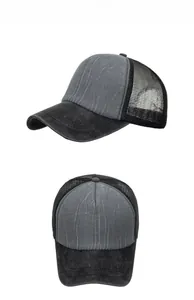 Detail view of two-tone mesh trucker hat with washed grey fabric and black mesh design