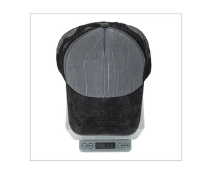 Detail shot showing the lightweight 69.4g trucker hat on a scale with breathable mesh