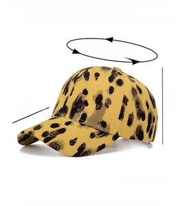 Detail view of mustard yellow leopard print baseball cap with golden stitching and brim