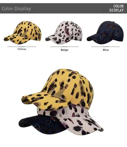Detail view of leopard print baseball caps with glitter accents in yellow, beige and blue