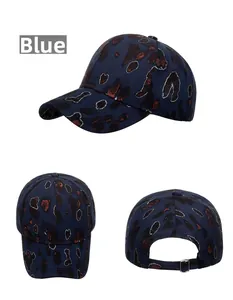 Detailed view of blue leopard print baseball cap with gold metallic trim and metal buckle