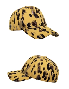 Detail view of stylish yellow leopard print baseball cap with contrast black spotted pattern