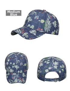Detail of medium blue baseball cap with white daisy floral and red berry print patterns