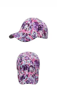 Detailed view of floral baseball cap with purple watercolor patterns and gold glitter accents