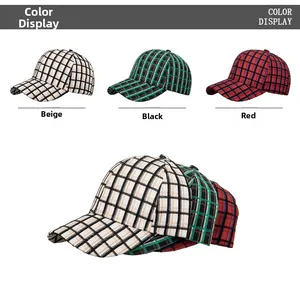 Macro detail of plaid baseball caps in beige and checkered patterns showing fabric texture