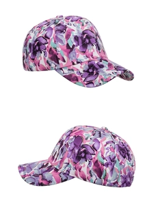 Detail view of the floral baseball cap showing watercolor patterns and gold glitter accents