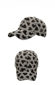 Detail shots of black baseball cap featuring white lace heart embroidery on front