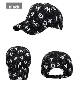 Close-up of black baseball cap featuring white letter patterns and metal buckle strap