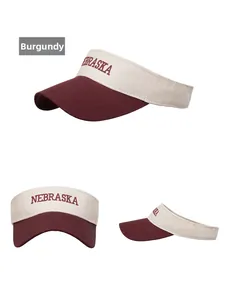 Detailed views of Nebraska letter embroidery on burgundy color-block sun visor hat