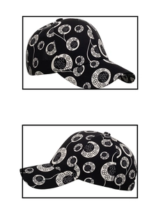 Detail view of black baseball cap with white clover print from multiple angles