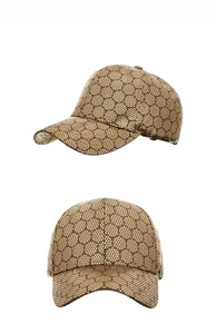 Detail view of the metallic gold baseball cap featuring black hexagonal honeycomb patterns