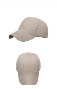 Detail of khaki breathable baseball cap with laser-cut ventilation holes and side lettering