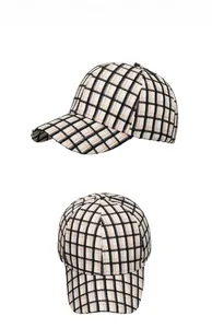Detail of the black, white, and orange plaid baseball cap with curved brim and 6-panel crown