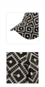 Détails de la broderie de marguerite blanche et coutures fines sur une casquette en coton noir