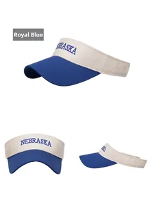 Detailed embroidery of Nebraska letters on a royal blue and cream sun visor hat