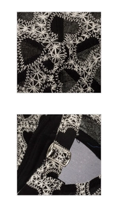 Detail of white geometric embroidery on black baseball cap and silver metal buckle