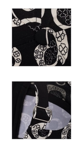 Detailed macro view of the clover print baseball cap showing the top button and metal strap buckle