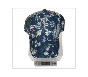 Weight measurement of the floral print baseball cap on digital scale showing 96.7g