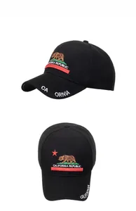 Close-up of the detailed California bear embroidery and red star on black cotton baseball cap