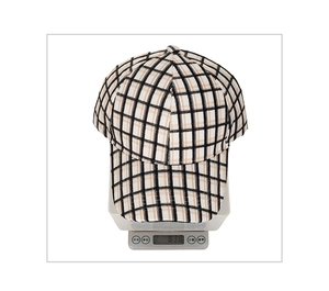 Detailed weight measurement showing a plaid baseball cap at 83.8g on a digital scale