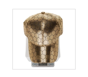 Macro detail of golden hexagon honeycomb texture on lightweight PU baseball cap